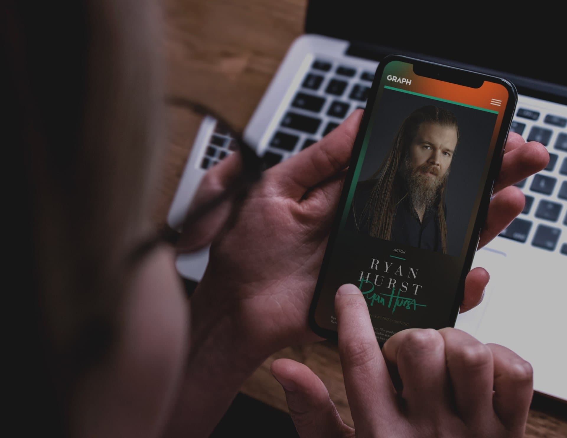 Person holding a phone with the Neon Mango website